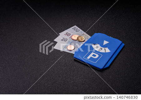 A parking disc, permit, or ticket for measuring time and paying municipal services. A parking disc A parking disc, permit, or ticket for measuring time and paying municipal services. A parking disc 140746830