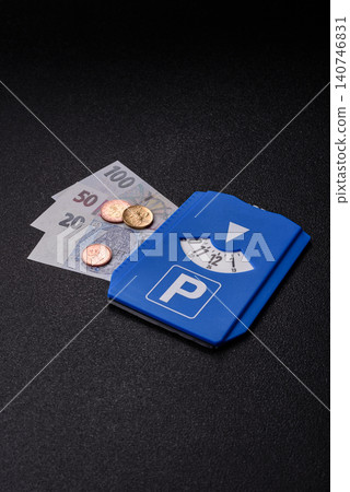 A parking disc, permit, or ticket for measuring time and paying municipal services. A parking disc A parking disc, permit, or ticket for measuring time and paying municipal services. A parking disc 140746831