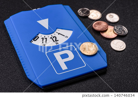 A parking disc, permit, or ticket for measuring time and paying municipal services. A parking disc A parking disc, permit, or ticket for measuring time and paying municipal services. A parking disc 140746834