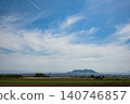 A ship's wake stretching across the summer sky and the city of Hakodate. 140746857
