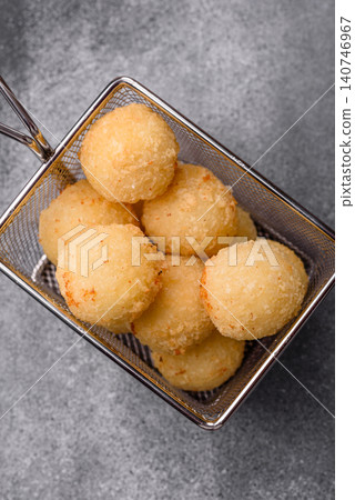 Cheese balls or potato croquettes, golden brown, fried with salt and spices. Cheese balls Cheese balls or potato croquettes, golden brown, fried with salt and spices. Cheese balls 140746967