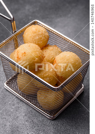 Cheese balls or potato croquettes, golden brown, fried with salt and spices. Cheese balls Cheese balls or potato croquettes, golden brown, fried with salt and spices. Cheese balls 140746968
