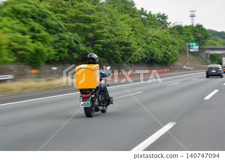Panning shot of a motorcycle traveling at high speed Panning shot of a motorcycle traveling at high speed 140747094