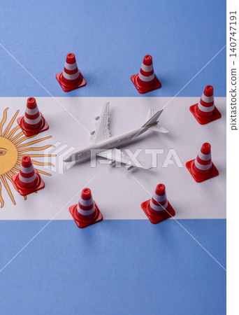 A mock up of airplane surrounded by no fly signs on a Argentine flag A mock up of airplane surrounded by no fly signs on a Argentine flag 140747191