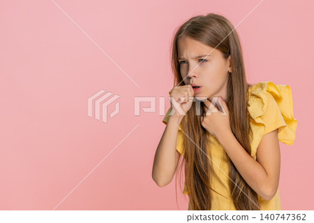 Little child girl kid touching sore throat coughing and showing discomfort with sad expression Little child girl kid touching sore throat coughing and showing discomfort with sad expression 140747362