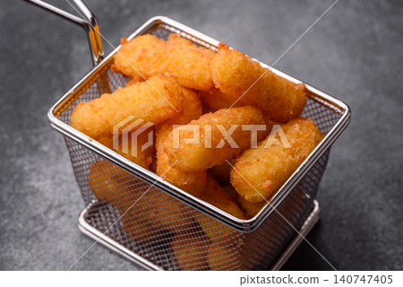 Mozzarella cheese sticks, breaded and fried with salt and tomato sauce, for takeaway. Cheese sticks Mozzarella cheese sticks, breaded and fried with salt and tomato sauce, for takeaway. Cheese sticks 140747405