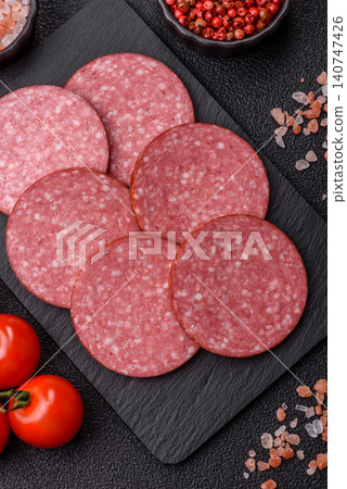 Slices of smoked salami or pepperoni for making sandwiches or pizza at home. Sausage slices Slices of smoked salami or pepperoni for making sandwiches or pizza at home. Sausage slices 140747426