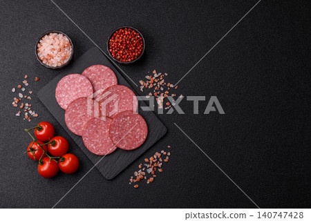 Slices of smoked salami or pepperoni for making sandwiches or pizza at home. Sausage slices 140747428