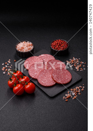 Slices of smoked salami or pepperoni for making sandwiches or pizza at home. Sausage slices Slices of smoked salami or pepperoni for making sandwiches or pizza at home. Sausage slices 140747429