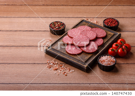 Slices of smoked salami or pepperoni for making sandwiches or pizza at home. Sausage slices Slices of smoked salami or pepperoni for making sandwiches or pizza at home. Sausage slices 140747430