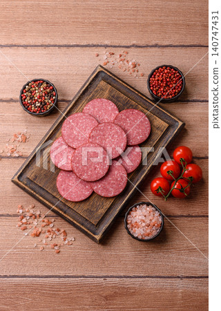 Slices of smoked salami or pepperoni for making sandwiches or pizza at home. Sausage slices Slices of smoked salami or pepperoni for making sandwiches or pizza at home. Sausage slices 140747431