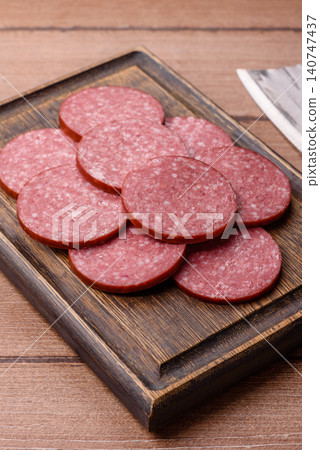 Slices of smoked salami or pepperoni for making sandwiches or pizza at home. Sausage slices 140747437