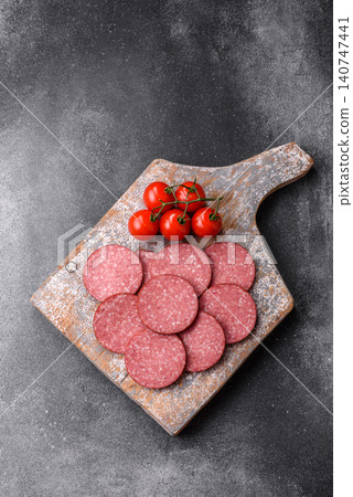 Slices of smoked salami or pepperoni for making sandwiches or pizza at home. Sausage slices 140747441