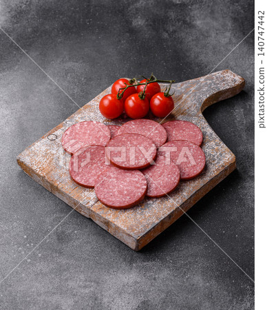 Slices of smoked salami or pepperoni for making sandwiches or pizza at home. Sausage slices 140747442