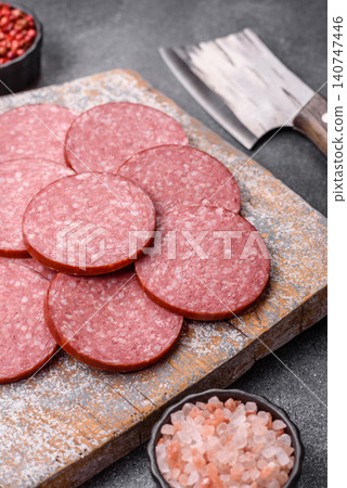 Slices of smoked salami or pepperoni for making sandwiches or pizza at home. Sausage slices 140747446