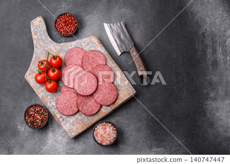 Slices of smoked salami or pepperoni for making sandwiches or pizza at home. Sausage slices Slices of smoked salami or pepperoni for making sandwiches or pizza at home. Sausage slices 140747447