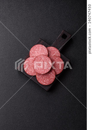 Slices of smoked salami or pepperoni for making sandwiches or pizza at home. Sausage slices 140747450
