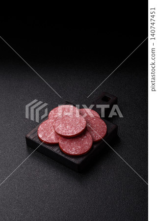 Slices of smoked salami or pepperoni for making sandwiches or pizza at home. Sausage slices Slices of smoked salami or pepperoni for making sandwiches or pizza at home. Sausage slices 140747451