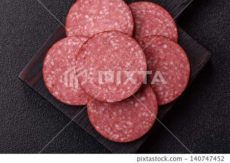 Slices of smoked salami or pepperoni for making sandwiches or pizza at home. Sausage slices 140747452