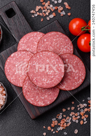 Slices of smoked salami or pepperoni for making sandwiches or pizza at home. Sausage slices 140747456