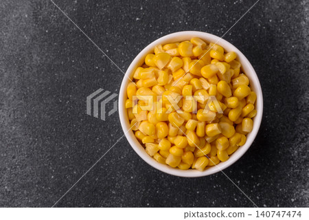 Golden, sweet canned corn kernels or maize for salads and vegetarian dishes. Canned corn 140747474