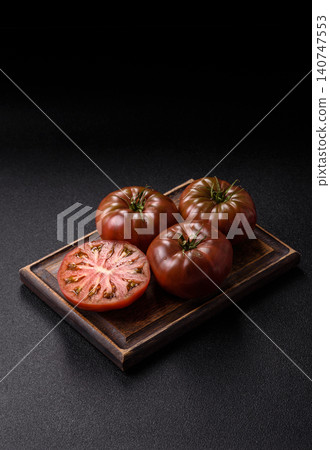 Fresh pink and black tomatoes adora or kumato as an ingredient for a salad. Tomatoes adora or kumato Fresh pink and black tomatoes adora or kumato as an ingredient for a salad. Tomatoes adora or kumato 140747553