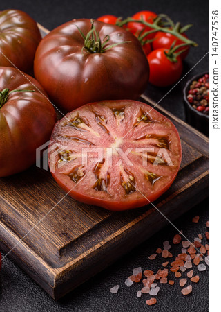 Fresh pink and black tomatoes adora or kumato as an ingredient for a salad. Tomatoes adora or kumato Fresh pink and black tomatoes adora or kumato as an ingredient for a salad. Tomatoes adora or kumato 140747558