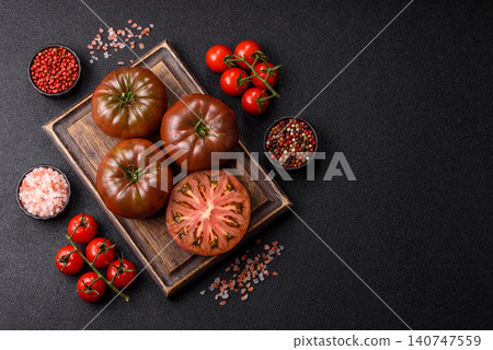 Fresh pink and black tomatoes adora or kumato as an ingredient for a salad. Tomatoes adora or kumato Fresh pink and black tomatoes adora or kumato as an ingredient for a salad. Tomatoes adora or kumato 140747559