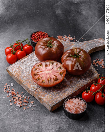 Fresh pink and black tomatoes adora or kumato as an ingredient for a salad. Tomatoes adora or kumato Fresh pink and black tomatoes adora or kumato as an ingredient for a salad. Tomatoes adora or kumato 140747563