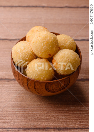 Cheese balls or potato croquettes, golden brown, fried with salt and spices. Cheese balls 140747699