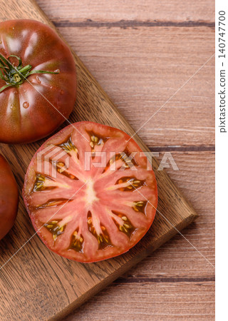 Fresh pink and black tomatoes adora or kumato as an ingredient for a salad. Tomatoes adora or kumato Fresh pink and black tomatoes adora or kumato as an ingredient for a salad. Tomatoes adora or kumato 140747700