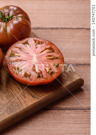 Fresh pink and black tomatoes adora or kumato as an ingredient for a salad. Tomatoes adora or kumato Fresh pink and black tomatoes adora or kumato as an ingredient for a salad. Tomatoes adora or kumato 140747701