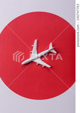 An airplane on the japanese flag as a conceptual backdrop. An airplane on the japanese flag 140747763