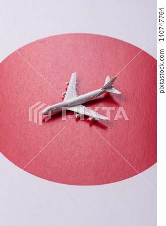 An airplane on the japanese flag as a conceptual backdrop. An airplane on the japanese flag An airplane on the japanese flag as a conceptual backdrop. An airplane on the japanese flag 140747764