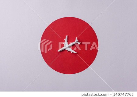 An airplane on the japanese flag as a conceptual backdrop. An airplane on the japanese flag An airplane on the japanese flag as a conceptual backdrop. An airplane on the japanese flag 140747765
