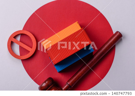 The cargo container ban on the japanese flag as a conceptual backdrop. The cargo container embargo The cargo container ban on the japanese flag as a conceptual backdrop. The cargo container embargo 140747793