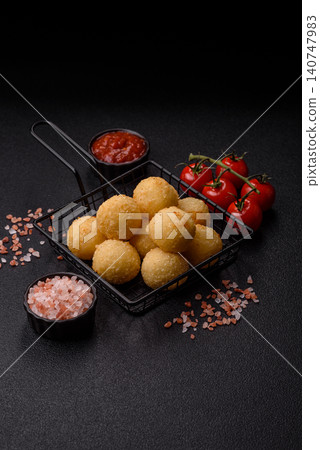 Cheese balls or potato croquettes, golden brown, fried with salt and spices. Cheese balls Cheese balls or potato croquettes, golden brown, fried with salt and spices. Cheese balls 140747983