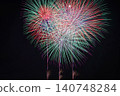 Colorful, large fireworks illuminate the night sky. 140748284