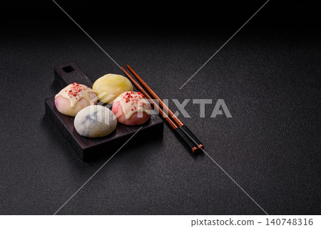 Japanese sweet frozen mochi with rice dough, fruit, and chocolate filling. Japanese mochi Japanese sweet frozen mochi with rice dough, fruit, and chocolate filling. Japanese mochi 140748316
