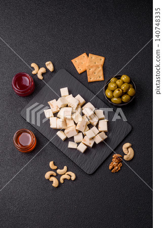White feta, tofu, or mozzarella cheese cubes with herbs. White mozzarella cheese White feta, tofu, or mozzarella cheese cubes with herbs. White mozzarella cheese 140748335