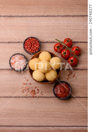 Cheese balls or potato croquettes, golden brown, fried with salt and spices. Cheese balls Cheese balls or potato croquettes, golden brown, fried with salt and spices. Cheese balls 140748377