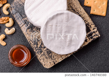 Brie or Camembert cheese is a white, round shape for baking and melting. Camembert cheese Brie or Camembert cheese is a white, round shape for baking and melting. Camembert cheese 140748380
