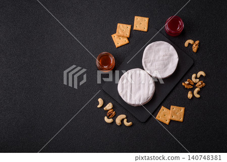 Brie or Camembert cheese is a white, round shape for baking and melting. Camembert cheese Brie or Camembert cheese is a white, round shape for baking and melting. Camembert cheese 140748381