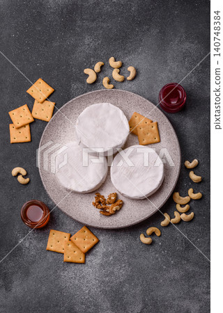 Brie or Camembert cheese is a white, round shape for baking and melting. Camembert cheese 140748384