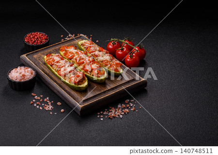 Baked zucchini half with minced meat, tomatoes, cheese, salt, and spices. Zucchini with minced meat Baked zucchini half with minced meat, tomatoes, cheese, salt, and spices. Zucchini with minced meat 140748511