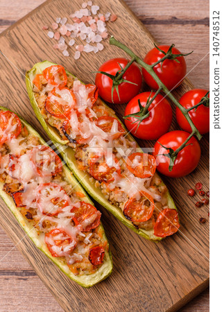 Baked zucchini half with minced meat, tomatoes, cheese, salt, and spices. Zucchini with minced meat Baked zucchini half with minced meat, tomatoes, cheese, salt, and spices. Zucchini with minced meat 140748512