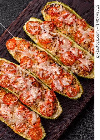 Baked zucchini half with minced meat, tomatoes, cheese, salt, and spices. Zucchini with minced meat Baked zucchini half with minced meat, tomatoes, cheese, salt, and spices. Zucchini with minced meat 140748515