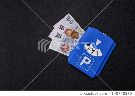 A parking disc, permit, or ticket for measuring time and paying municipal services. A parking disc A parking disc, permit, or ticket for measuring time and paying municipal services. A parking disc 140748570