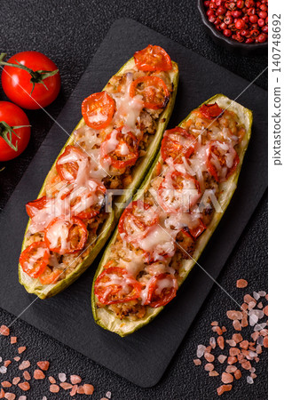 Baked zucchini half with minced meat, tomatoes, cheese, salt, and spices. Zucchini with minced meat Baked zucchini half with minced meat, tomatoes, cheese, salt, and spices. Zucchini with minced meat 140748692