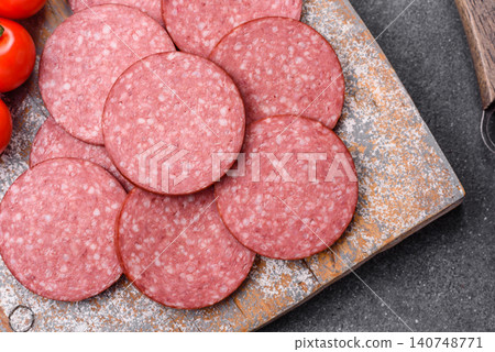 Slices of smoked salami or pepperoni for making sandwiches or pizza at home. Sausage slices Slices of smoked salami or pepperoni for making sandwiches or pizza at home. Sausage slices 140748771
